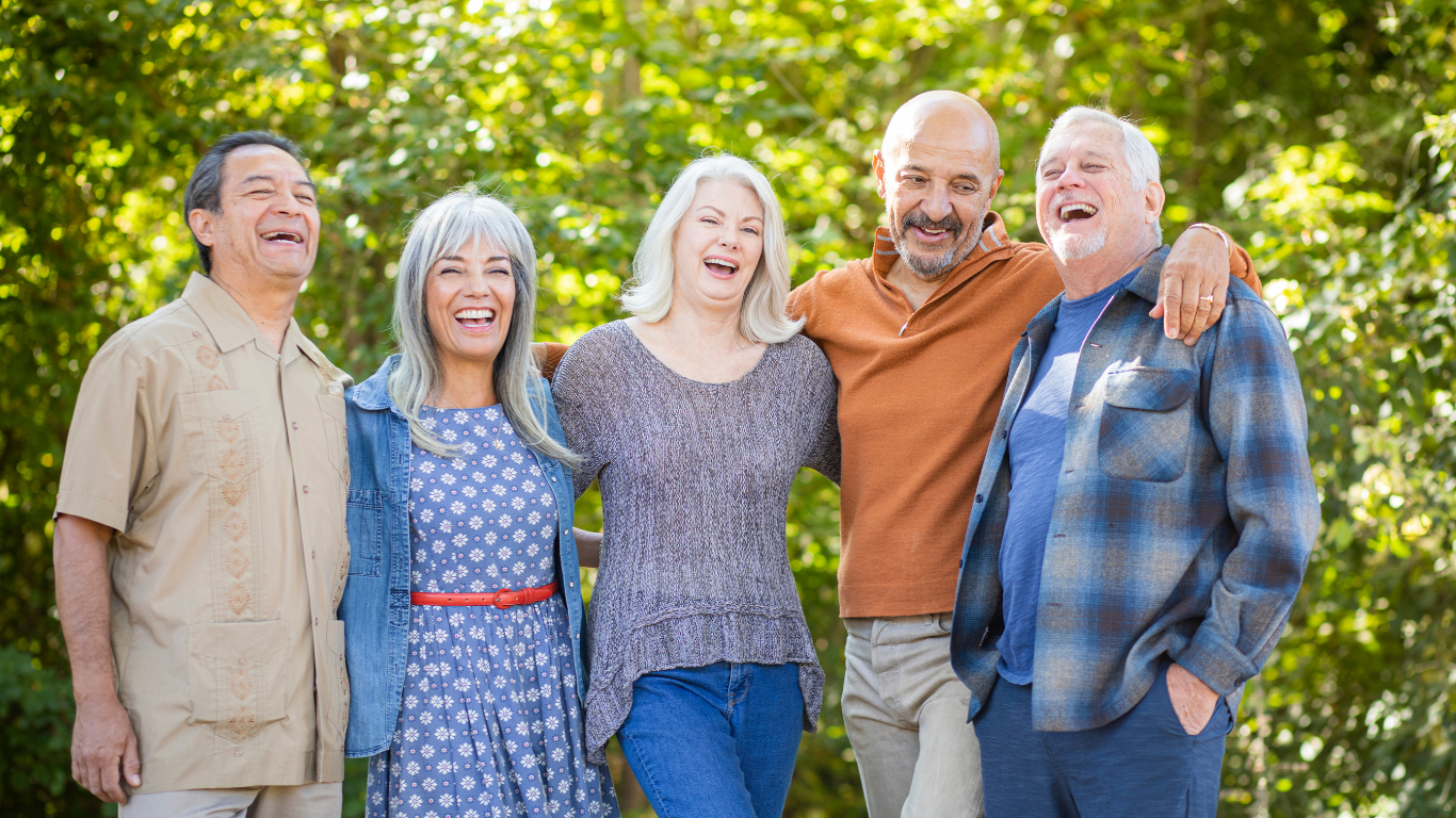 5 older adults pose outside for a photo