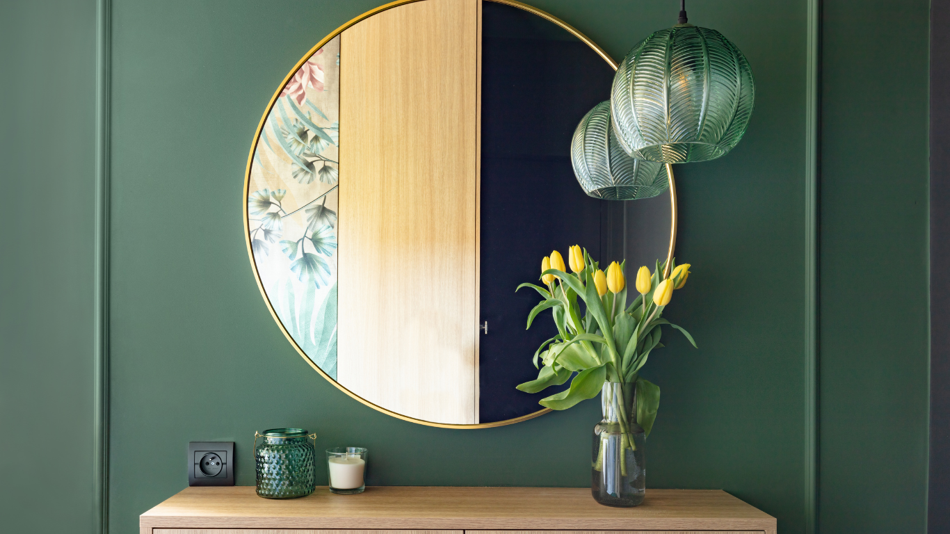 A mirror with a console underneath it and yellow tulips on the console